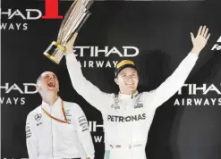  ??  ?? ABU DHABI: Mercedes AMG Petronas F1 Team’s German driver Nico Rosberg (front) celebrates at the end of the Abu Dhabi Formula One Grand Prix at the Yas Marina circuit yesterday. Nico Rosberg won his maiden Formula One world title by securing second...