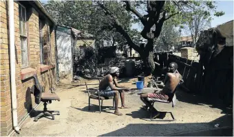  ??  ?? Parkson and Solomon Muvi, brothers in the yard of their home. Main picture, Yonela Mkalipi and her son Omphile Makubung outside their home in Crown Mines village.