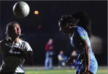  ?? RECORDER PHOTOS BY CHIEKO HARA ?? Monache High School’s Zoe Rios, right, heads a ball Tuesday, Dec. 4, during the first half of a game against El Diamante High School at Monache.