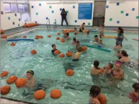  ?? CHAD FELTON — THE NEWS-HERALD ?? Families frolic with abandon on Oct. 28 during West End YMCA Aquatic Pumpkin Splash in Willoughby. The event has been taking place for 15-plus years.