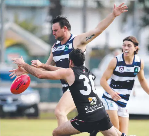  ?? Picture: STEWART McLEAN ?? WELL-OILED MACHINE: Port Douglas Crocs' Daniel Moore and Cairns Saints' Brock Bish go head to head in Round 11 at Griffiths Park.