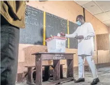  ?? /AFP ?? Election day: Benin President Patrice Talon wears a mask to cast his ballot at the Charles Guiyot Zongo public school on May 17.