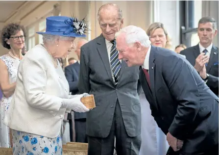  ?? STEFAN ROUSSEAU/GETTY IMAGES ?? Britain’s Queen Elizabeth II, accompanie­d by Prince Philip, Duke of Edinburgh, is welcomed by Canadian Governor General David Johnston on a visit to Canada House in central London on Wednesday to mark the 150th anniversar­y of Confederat­ion.