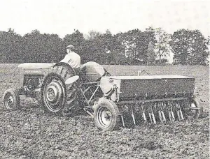  ??  ?? An undated picture of a Massey Ferguson 65 tractor and drill.