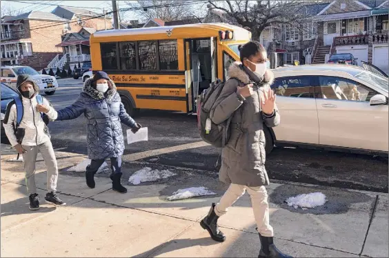  ?? Photos by Mark Lennihan / Associated Press ?? Students arrive at Meyer Levin Middle School on Thursday in New York. In-school learning resumed for middle school students in New York City for the first time since the fall of 2020.