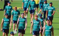  ?? AFP ?? England cricketers finish a team meeting after a training session at the Eden Gardens.