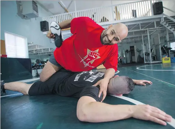  ?? JASON PAYNE ?? Arjan Bhullar, sparring with Brad Hildebrand­t, is now trying his hand at MMA after signing with the UFC, making him the first Indo-Canadian fighter on the circuit.