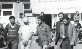  ?? KAVEH KAZEMI/GETTY IMAGES FILE PHOTO ?? A blindfolde­d American hostage is led in front of the media by students who stormed the U.S.embassy and took diplomatic staff hostage in Tehran, Iran.