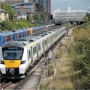  ?? ALEX DASI-SUTTON. ?? The RMT wants the three principal ROSCOs nationalis­ed. On August 19, Govia Thameslink Railway 700039 (owned by CrossLondo­n Trains) leaves Wimbledon with the 1014 Luton-Sutton, as South West Trains 450124 (owned by Angel Trains) powers the 1129 London...