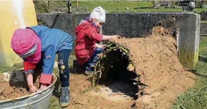  ??  ?? Ella (vorn) und Maja hatten mächtigen Spaß beim Ofenbauen mit einem Gemisch aus viel Lehm und etwas Stroh. Am Ende brannte in der kleinen Höhle sogar ein Feuer. Fotos: Joachim Siegert ()