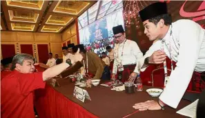  ??  ?? Well done: Ahmad Zahid giving a thumbs up to Khairy on the sidelines of the meeting.