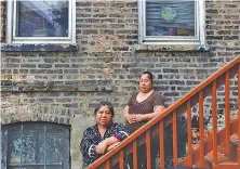  ?? AP PHOTO/SHAFKAT ANOWAR ?? Maria Elena Estamilla, 62, left and her daughter Esmeralda Triquiz in Chicago’s Pilsen neighborho­od.