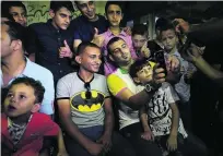  ?? Said Khatib / AFP ?? Palestinia­n singer Adel Meshoukhi, centre, poses for pictures with fans at a wedding in Rafah in southern Gaza Strip.