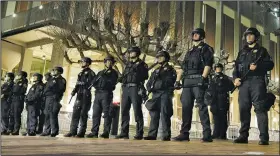  ?? AP/BEN MARGOT ?? Police officers stand guard Feb. 1 at the University of California, Berkeley, outside the building where right-wing writer Milo Yiannopoul­os was scheduled to speak, before a violent outbreak forced the cancellati­on of his event.