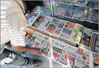  ?? Picture: REUTERS ?? HOT OFF THE PRESS: A newspaper vendor arranges newspapers showing front pages with images of Kim Jong-Nam at a newsstand outside Kuala Lumpur in Malaysia yesterday