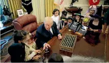  ?? PHOTO: REUTERS ?? President Donald Trump gives out Halloween treats to children of members of press and White House staff in the Oval Office of the White House.