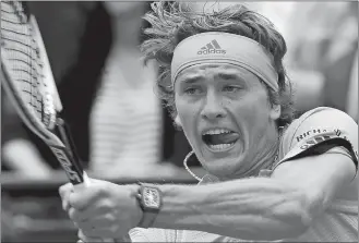  ?? MICHEL EULER/AP PHOTO ?? Alexander Zverev returns a shot against Damir Dzumhur during their third round match on Friday in the French Open at the Roland Garros stadium in Paris.