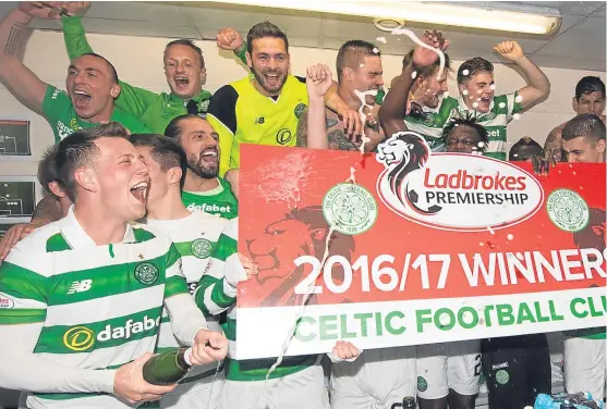  ?? Picture: SNS. ?? The Celtic players were popping the Champagne corks after a 5-0 drubbing of Hearts sealed the Premiershi­p title.