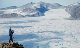  ??  ?? Luke Copland taking a photo of fractures in the Milne ice shelf. Photograph: Adrienne