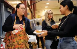  ??  ?? Kristi Kooger serves Priscilla Gaines pumpkin pie as Linda Martinez, middle, waits as the Lodi Boys and Girls Club hosts a Thanksgivi­ng dinner for member families in Lodi on Thursday.