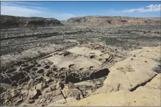  ?? CEDAR ATTANASIO/AP ?? A HIKER SITS ON A LEDGE above Pueblo Bonito, the largest archeologi­cal site at the Chaco Culture National Historical Park, in northweste­rn New Mexico, on Aug. 28, 2021.