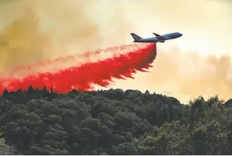  ?? Carlos Avila Gonzalez / the Chronicle ?? Cal Fire’s 747 Global Supertanke­r drops fire retardant on the Walbridge Fire, part of the LNU Lightning Complex, near Mountain View Ridge Road west of Healdsburg on Friday.