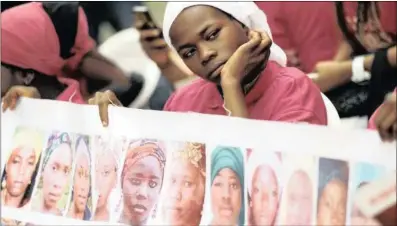  ?? REUTERS ?? A Bring Back Our Girls campaigner looks on during an earlier protest over the abduction of girls from the village of Chibok in 2014.PICTURE: