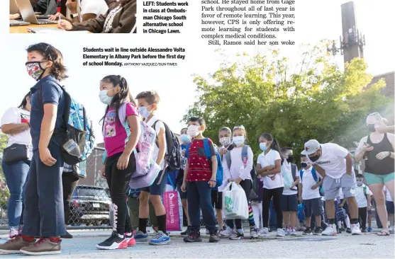  ?? ANTHONY VAZQUEZ/SUN-TIMES ?? Students wait in line outside Alessandro Volta Elementary in Albany Park before the first day of school Monday.