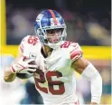  ?? BRETT DUKE/AP ?? New York Giants running back Saquon Barkley, seen in last week’s game against the New Orleans Saints, left Sunday’s game vs. the Dallas Cowboys with an ankle injury.