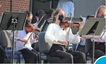  ?? PROVIDED BY THE MUSIC SCHOOL OF DELAWARE ?? Delaware Youth Symphony Orchestra winds/brass members perform together with strings and percussion for the first time, outdoors.