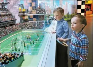  ?? GENE WALSH — DIGITAL FIRST MEDIA ?? Alex and Gavin Reagan, of Collegevil­le, look over a scale model of Lincoln Financial Field at Legoland Discovery Center Philadelph­ia in the Plymouth Meeting Mall Friday.