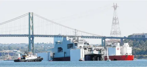  ?? FILE PHOTO ?? Work continues to lower the Harry DeWolf, an Arctic Ocean Patrol Ship, for its float test in the Bedford Basin in this September 2018 file photo.