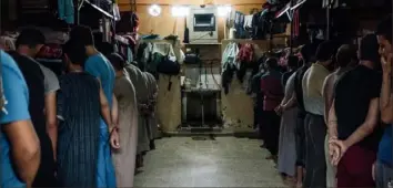  ??  ?? Prisoners, who were ordered to turn away from the camera, June 1 in Qamishli, Syria.