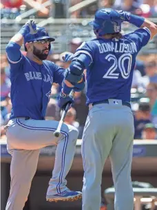  ?? BRAD REMPEL, USA TODAY SPORTS ?? Jose Bautista, left, and Josh Donaldson, celebratin­g a Bautista home run, say the Blue Jays won’t tone down their approach.