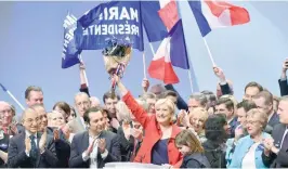  ?? — AFP ?? Marine Le Pen acknowledg­es applause after she delivered a speech during a campaign rally at the Zenith venue on Sunday in Lille.