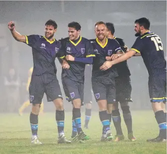  ??  ?? Sam Smith (left) raises his arm after scoring one of his 10 goals for Gold Coast City. TERRY WILSON