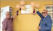  ??  ?? Dr Mawalall Chatroogho­on, of the Divine Life Society of SA, and principal Lajeeth Maharaj unveil a plaque to mark the opening of the school’s four new classrooms.