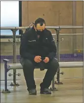  ??  ?? A man sits on a bench waiting for a tube train at Westminste­r Undergroun­d station.