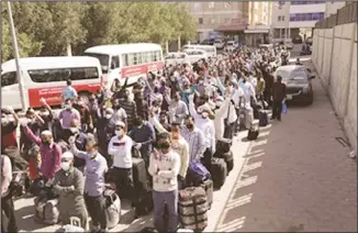  ??  ?? Bangladesh­is seen queuing to register to leave.