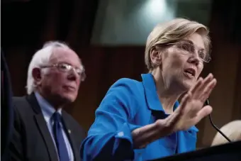  ?? AP FILE PHOTOS ?? LASTING DAMAGE: U.S. Sens. Elizabeth Warren and Bernie Sanders unveil their Medicare for All legislatio­n in 2017; Warren, below left and right, speaks about her foreign policy vision last month at the American University Washington College of Law in Washington, D.C.