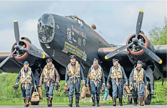  ??  ?? An RAF crew returning to base in a re-enactment of a Second World War sortie at the Yorkshire Air Museum this weekend. More than 100 actors are recreating the atmosphere of an operationa­l airbase and exhibits include the museum’s unique Halifax Bomber,...