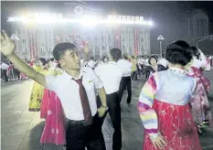  ?? JON CHOL JIN/THE ASSOCIATED PRESS ?? North Koreans dance in Kim Il Sung Square in Pyongyang, North Korea, on Thursday to celebrate the launch of North Korea’s first interconti­nental ballistic missile two days earlier.