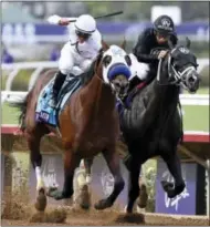 ?? DENIS POROY — THE ASSOCIATED PRESS ?? Jockey Flavien Prat, left, rides Battle of Midway to victory ahead of Sharp Azteca, ridden by Paco Lopez, in the Las Vegas Dirt Mile horse race during the first day of the Breeders’ Cup Friday in Del Mar