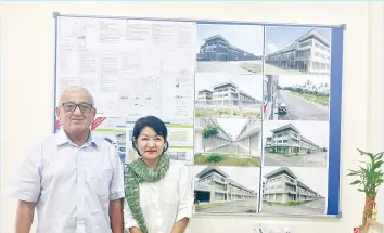  ??  ?? Annie (right) and Poi posing with pictures of the completed One Marudu Commercial Centre.