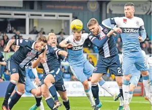  ??  ?? Rangers’ Michael O’Halloran gets in a header in a packed County box.