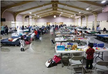  ?? PHOTOS BY SHAE HAMMOND — STAFF PHOTOGRAPH­ER ?? People stay in an evacuation area at Santa Cruz County Fairground­s on Sunday.
