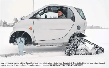  ?? ERIC MCCARTHY/JOURNAL PIONEER ?? Jarrett Martin shows off the Smart Car he’s converted into a wintertime Smart sled. The sight of the car powering through snow-covered fields has lots of people snapping photos.
