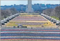  ?? [ALEX BRANDON/ THE ASSOCIATED PRESS] ?? Flags are placed on the National Mall, looking towards the Washington Monument, and the Lincoln Memorial, ahead of the inaugurati­on of President-elect Joe Biden and Vice Presidente­lect Kamala Harris, Monday in Washington.