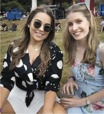  ??  ?? Katie Doherty and Eleanor Quaine from Longford enjoy the summer weather and the atmosphere at Groove Festival at Killrudder­y House, Bray. Photo: Tony Gavin