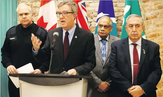  ?? TONY CALDWELL ?? Ottawa Mayor Jim Watson, joined by Ottawa police Chief Charles Bordeleau, left, and councillor­s Shad Qadri and Eli El-Chantiry, right, provide an update on the Ottawa Street Violence and Gang Strategy at city hall on Friday. Watson and Bordeleau...